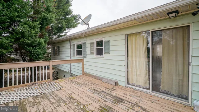 a view of a house with a wooden deck