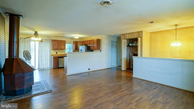 a view of a kitchen with a refrigerator and a stove top oven
