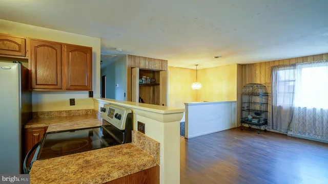 a kitchen with sink cabinets and wooden floor
