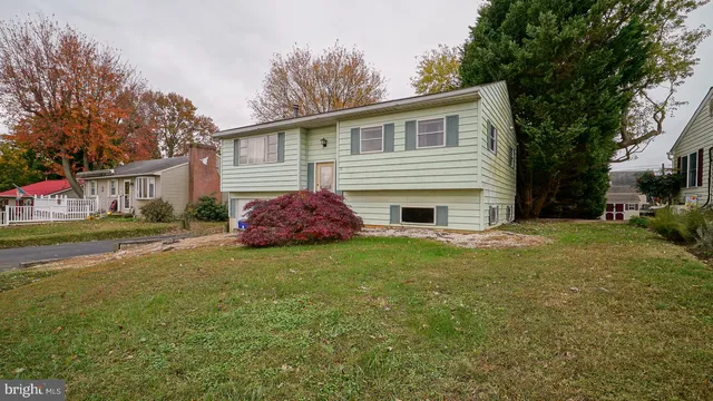 a front view of house with yard and trees