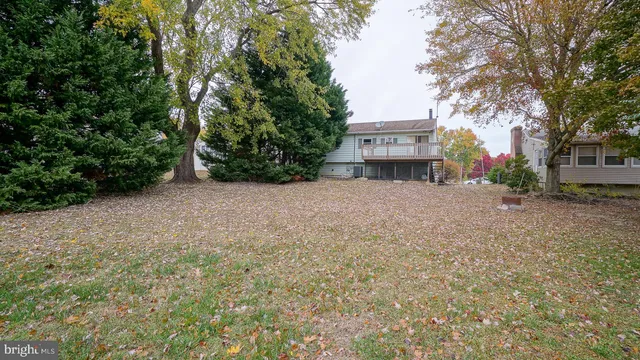 a view of a house with a tree and a yard