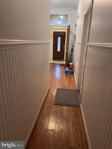 a view of a hallway view with wooden floor and staircase
