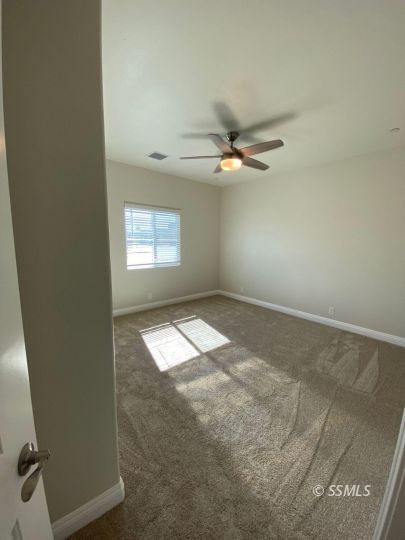 1049 Ocean Avenue Ridgecrest, CA 93555 - Photo 17 of 19 an empty room with windows and fan