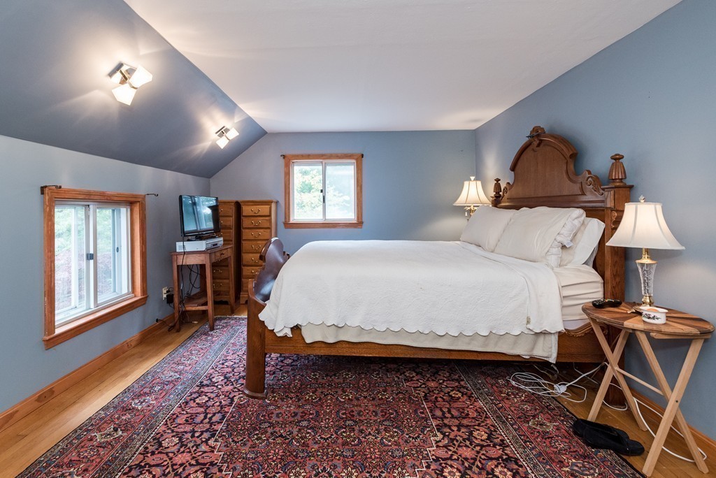 41 Watertown Street Lexington, MA 02421 - Photo 14 of 23 a bed room with a bed and a lamp