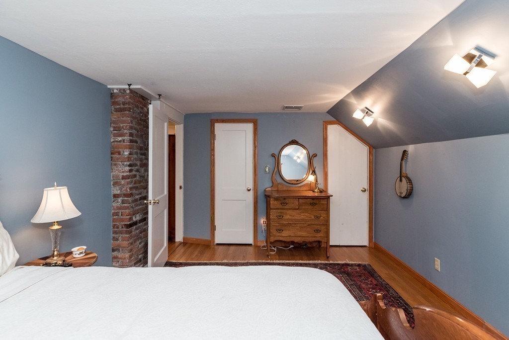 41 Watertown Street Lexington, MA 02421 - Photo 15 of 23 a bedroom with a bed and a lamp on dresser
