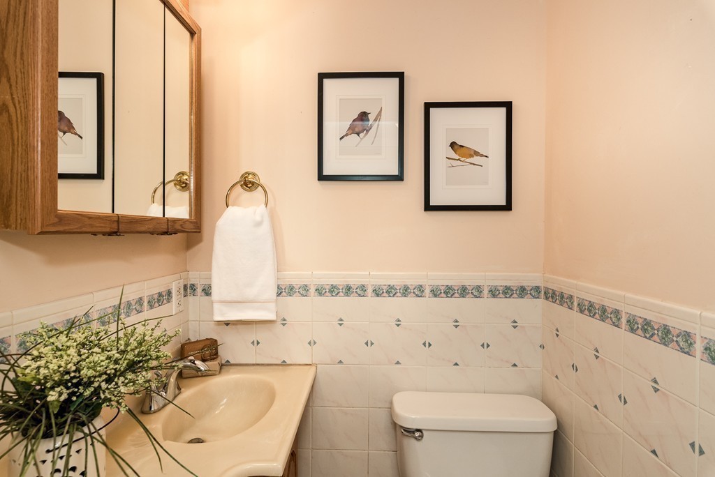 41 Watertown Street Lexington, MA 02421 - Photo 20 of 23 a bathroom with a toilet sink and mirror
