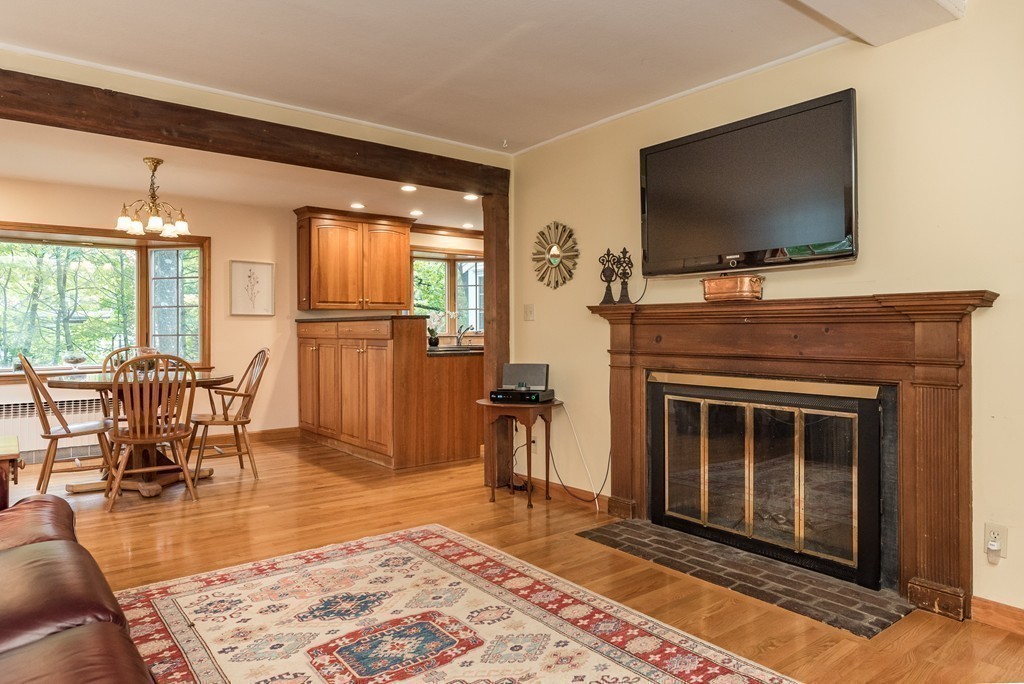 41 Watertown Street Lexington, MA 02421 - Photo 9 of 23 a living room with furniture a flat screen tv and a fireplace