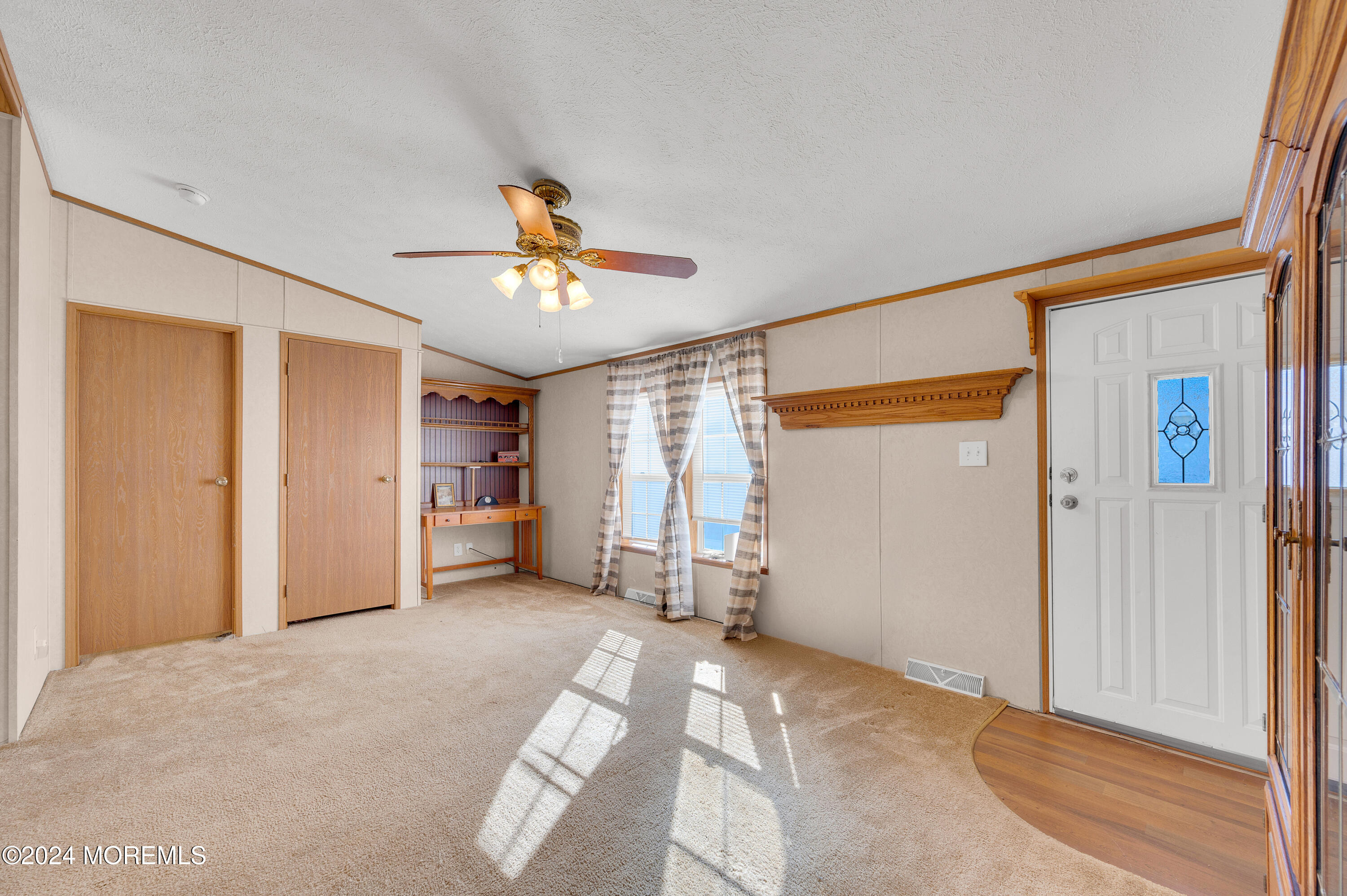 2 Baltimore Avenue Manahawkin, NJ 08050 - Photo 4 of 20 a view of a livingroom with a chandelier fan and windows