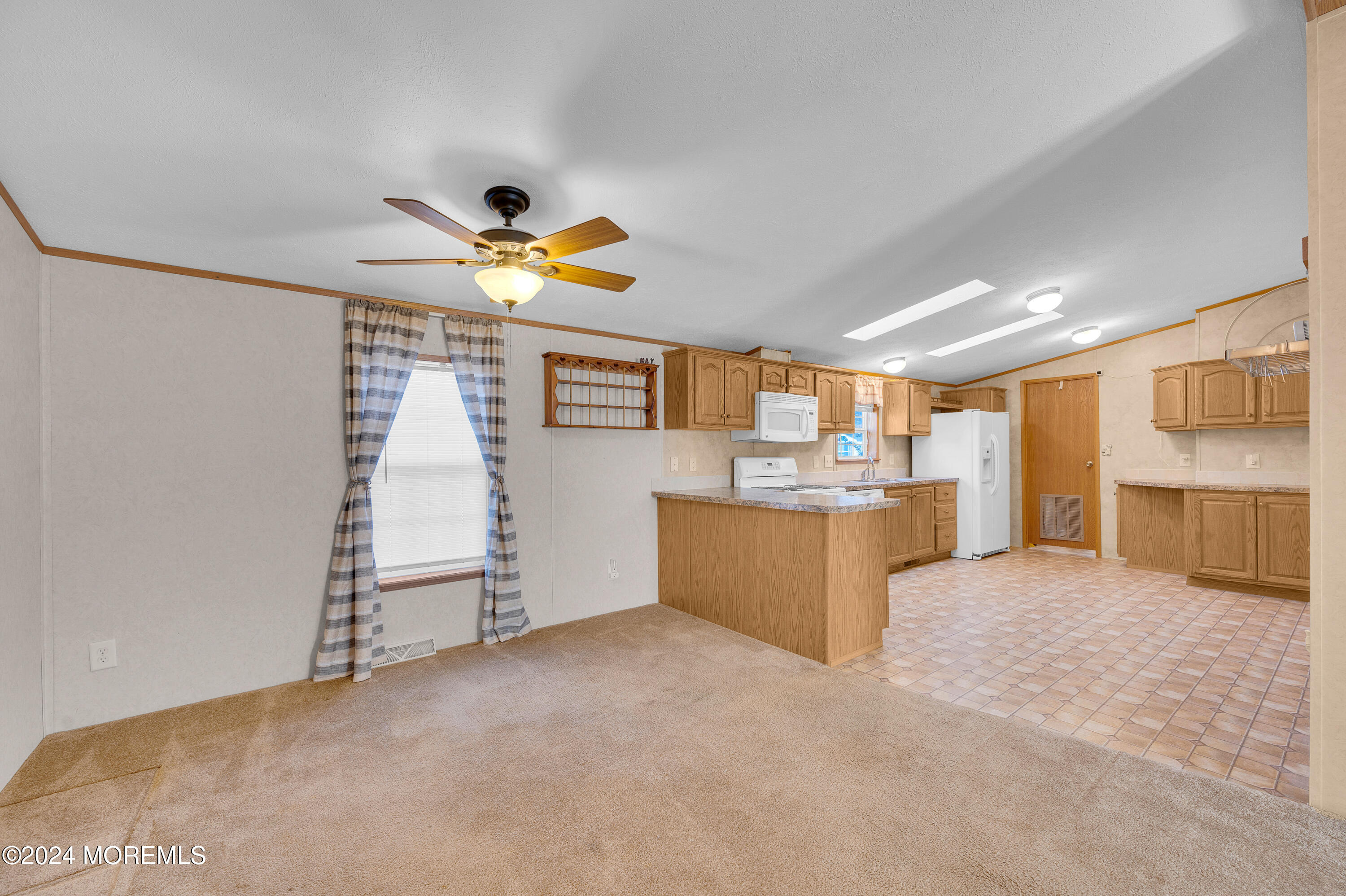 2 Baltimore Avenue Manahawkin, NJ 08050 - Photo 7 of 20 a view of a kitchen with a sink and a refrigerator