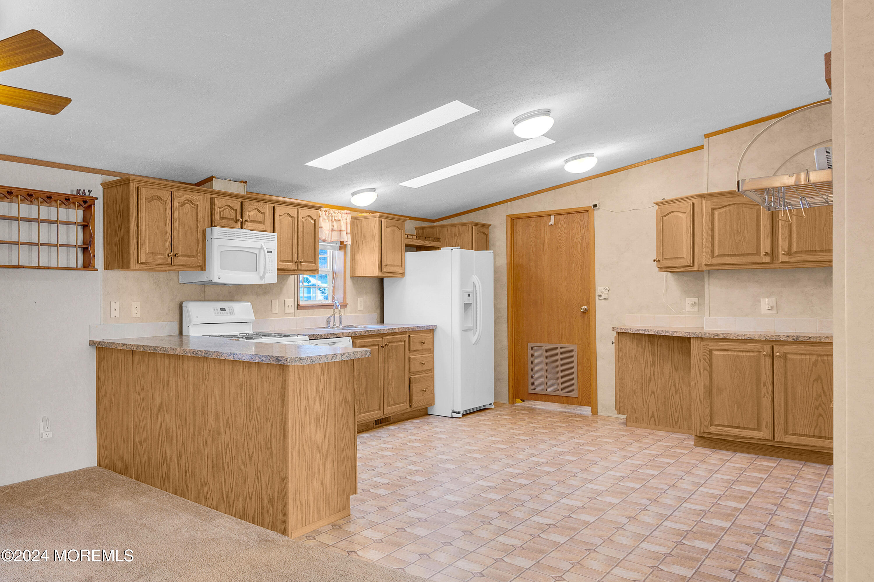 2 Baltimore Avenue Manahawkin, NJ 08050 - Photo 8 of 20 a kitchen with stainless steel appliances granite countertop a sink stove and refrigerator