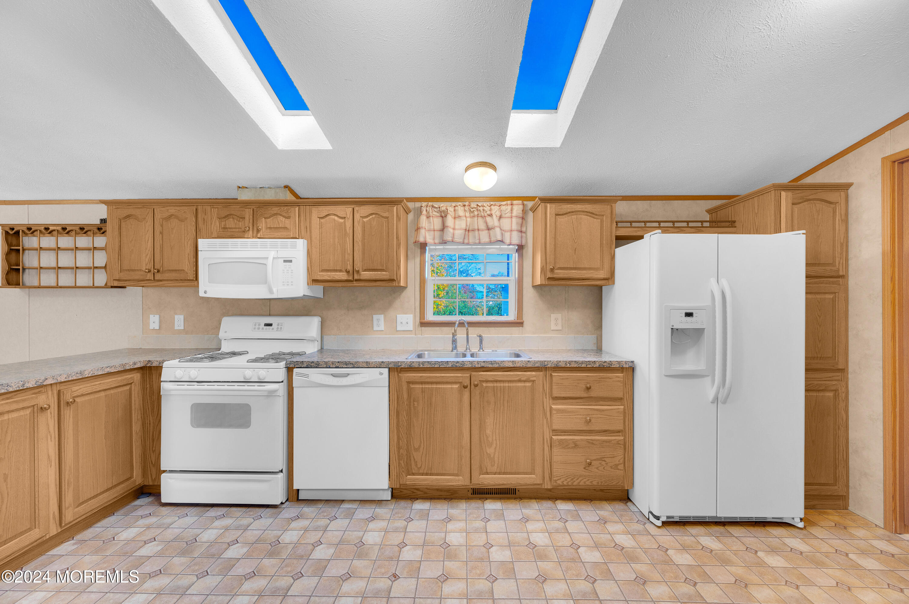 2 Baltimore Avenue Manahawkin, NJ 08050 - Photo 9 of 20 a kitchen with a stove a sink and a refrigerator