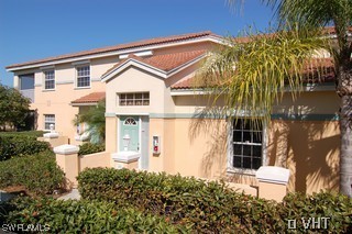 10751 Halfmoon Shoal Road, Unit 201 Bonita Springs, FL 34135 - Photo 1 of 8 a front view of a house with a yard