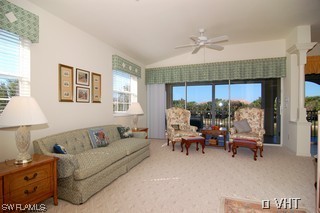 10751 Halfmoon Shoal Road, Unit 201 Bonita Springs, FL 34135 - Photo 2 of 8 a living room with furniture and a large window