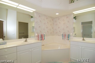 10751 Halfmoon Shoal Road, Unit 201 Bonita Springs, FL 34135 - Photo 6 of 8 a bathroom with a sink and a mirror