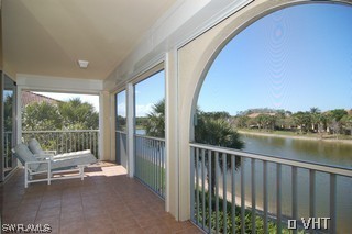 10751 Halfmoon Shoal Road, Unit 201 Bonita Springs, FL 34135 - Photo 7 of 8 a balcony with chairs