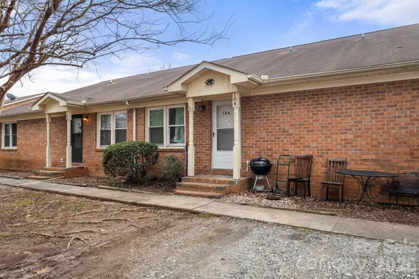 a front view of a house with glass windows and yard