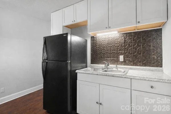 a kitchen with a refrigerator and a sink