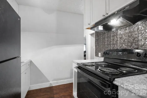 a stove top oven sitting inside of a kitchen