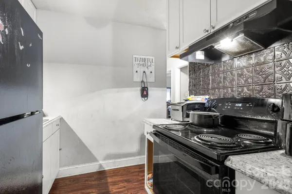 a stove top oven sitting inside of a kitchen