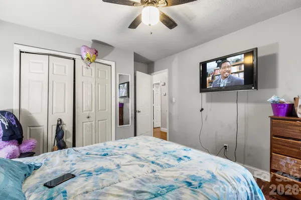 a bedroom with a bed and a flat screen tv