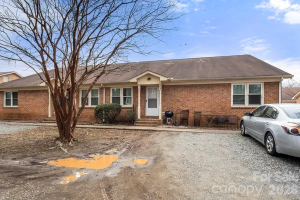 a front view of a house with yard outdoor seating and barbeque oven
