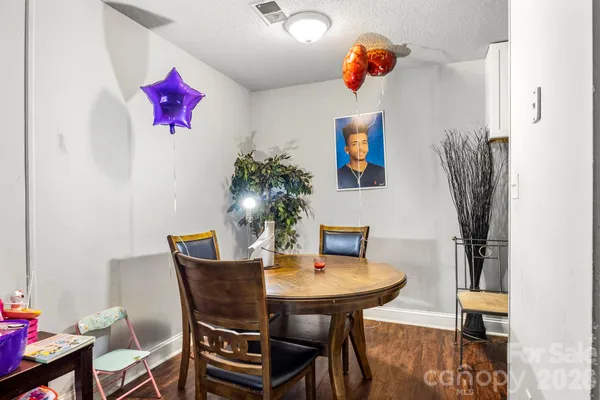a dining room with furniture and wooden floor