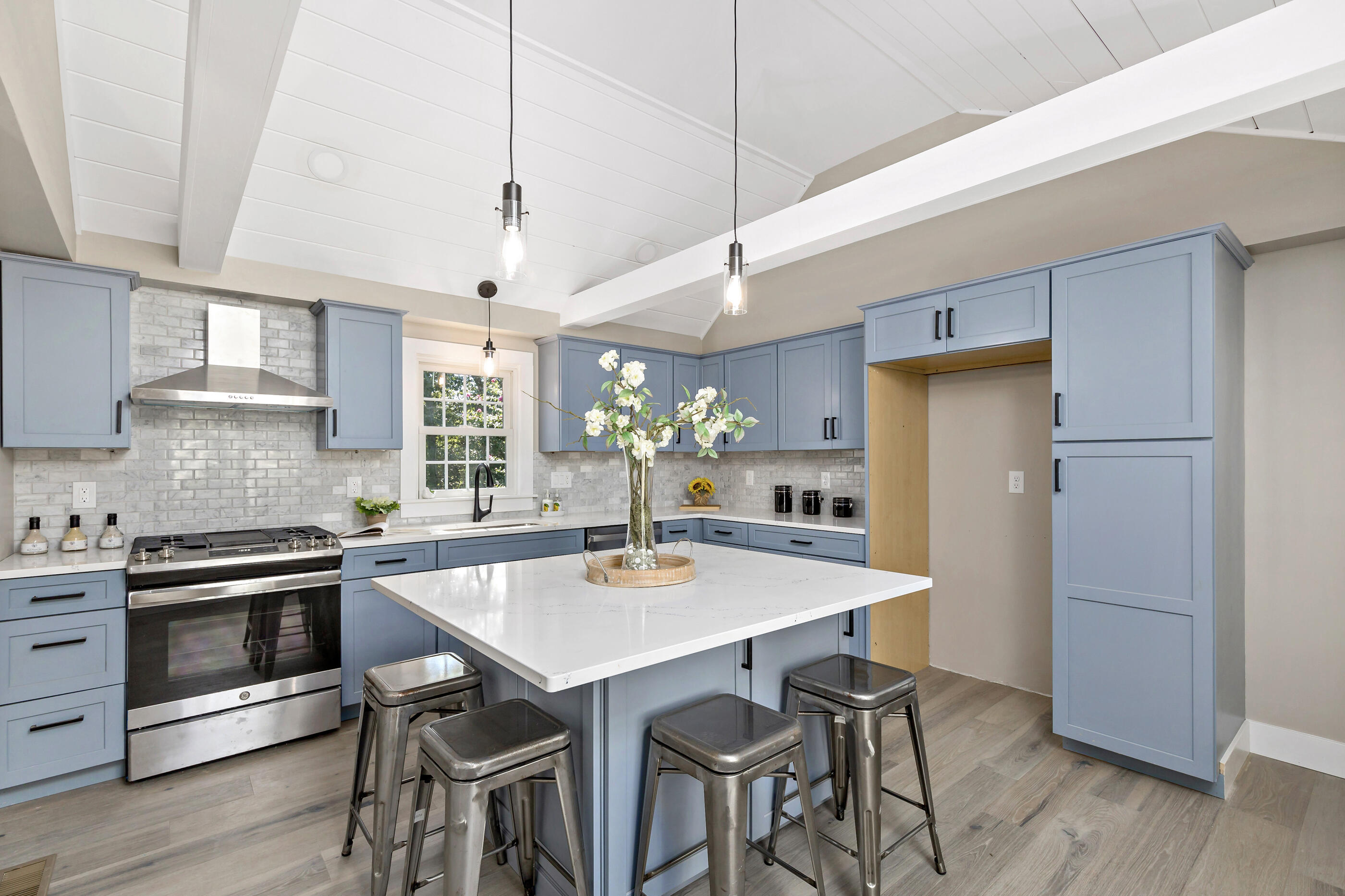 53 Monument Neck Road Bourne, MA 02532 - Photo 14 of 44 a kitchen with stainless steel appliances granite countertop a dining table chairs stove refrigerator and cabinets