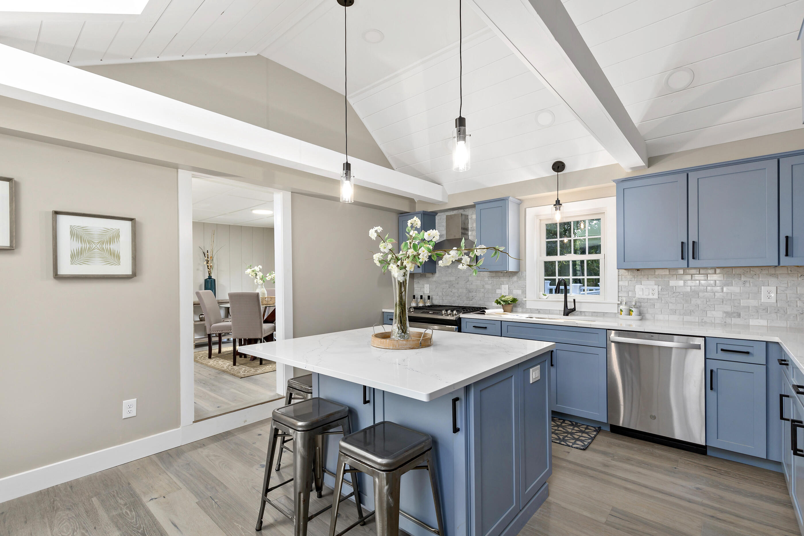 53 Monument Neck Road Bourne, MA 02532 - Photo 15 of 44 a kitchen with a table chairs and wooden floor