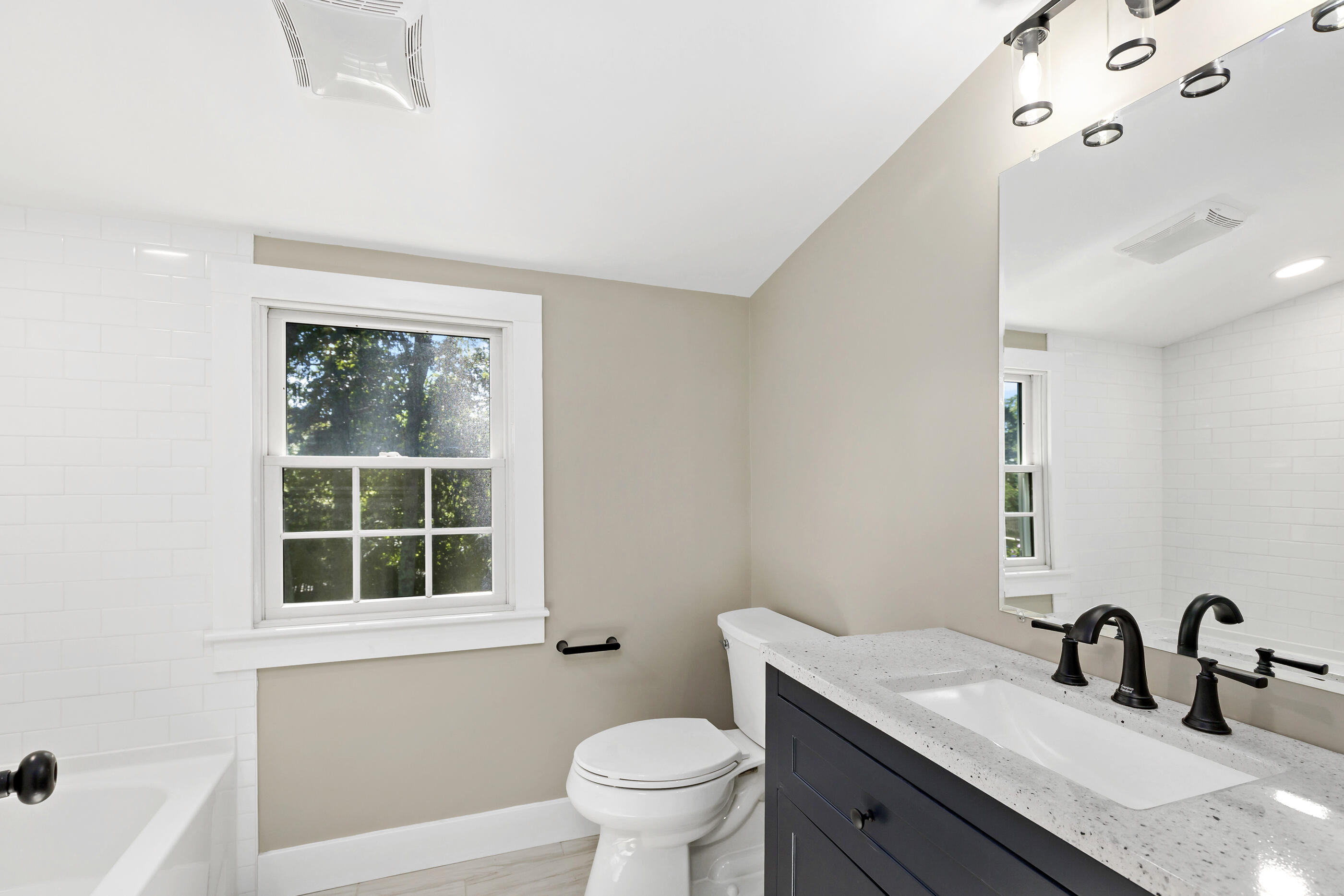 53 Monument Neck Road Bourne, MA 02532 - Photo 35 of 44 a bathroom with a granite countertop sink a toilet and a large mirror