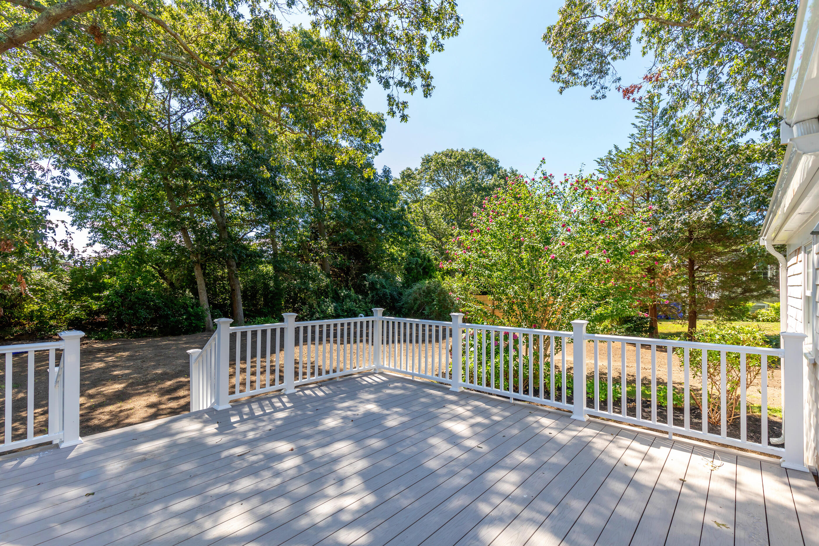 53 Monument Neck Road Bourne, MA 02532 - Photo 4 of 44 a view of a deck with a large window and wooden fence