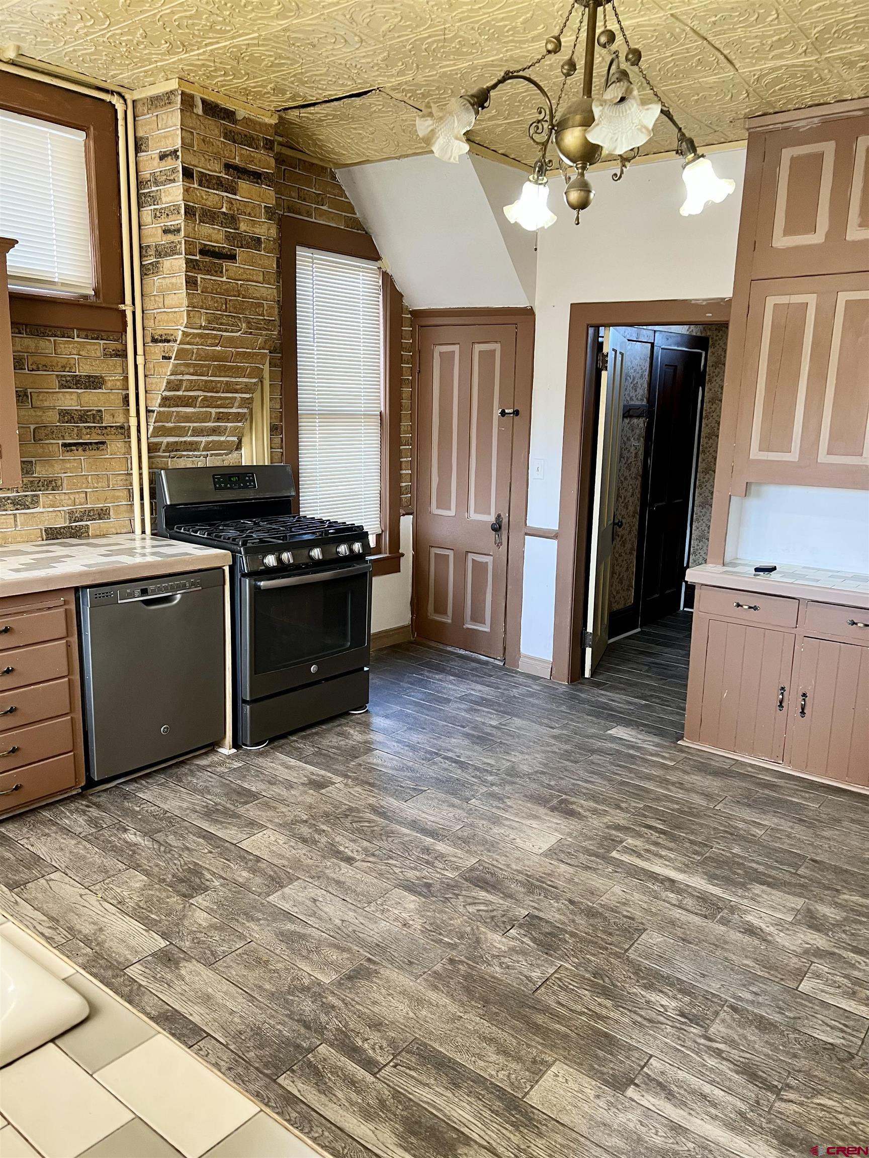 509 Leon Street Delta, CO 81416 - Photo 20 of 35 a kitchen with stainless steel appliances granite countertop a stove and a refrigerator