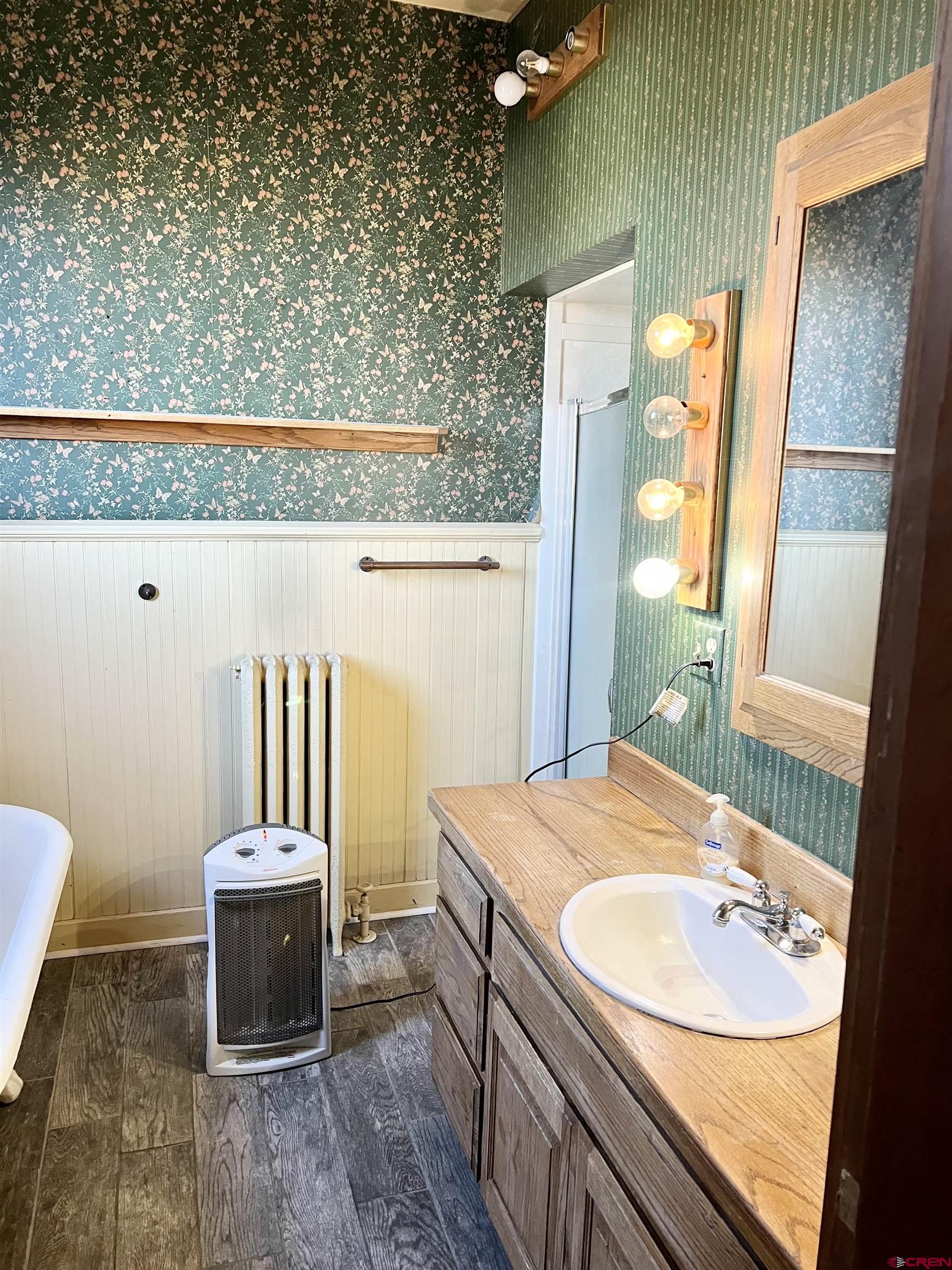 509 Leon Street Delta, CO 81416 - Photo 22 of 35 a bathroom with a granite countertop sink and a mirror