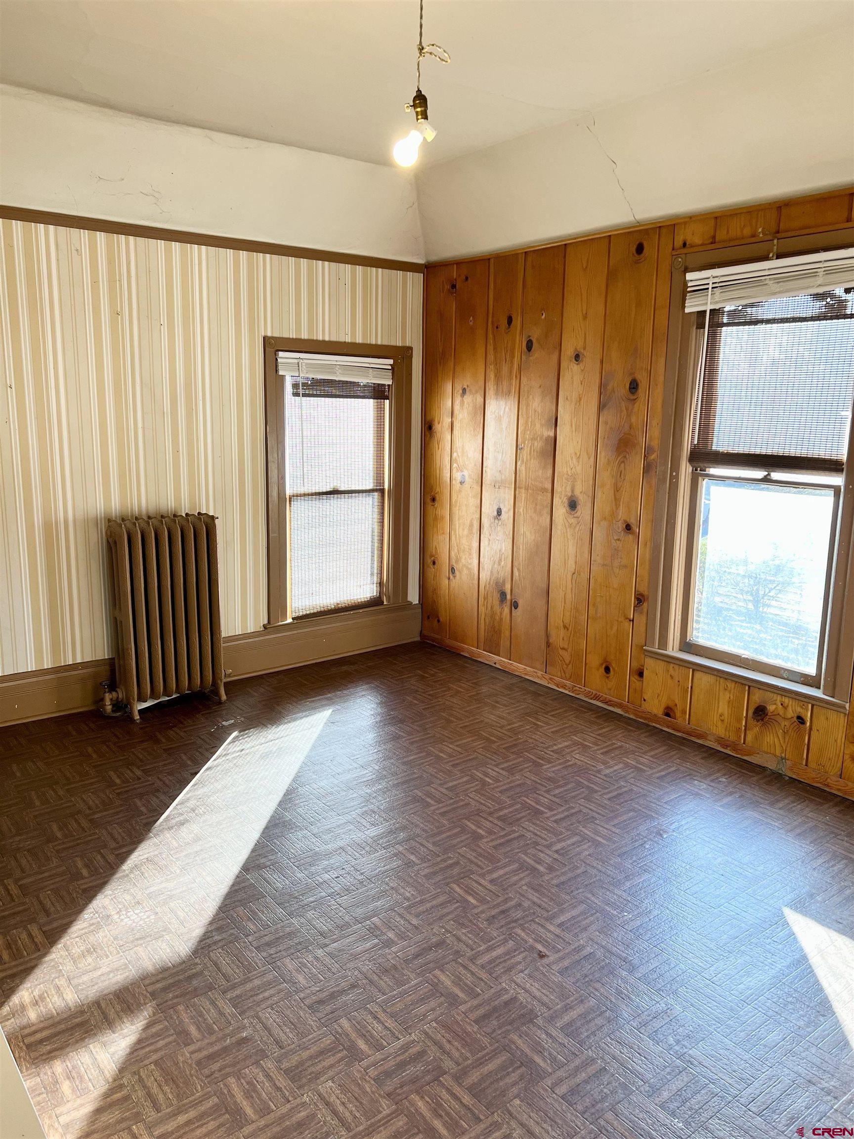 509 Leon Street Delta, CO 81416 - Photo 32 of 35 a view of an empty room with wooden floor and a window
