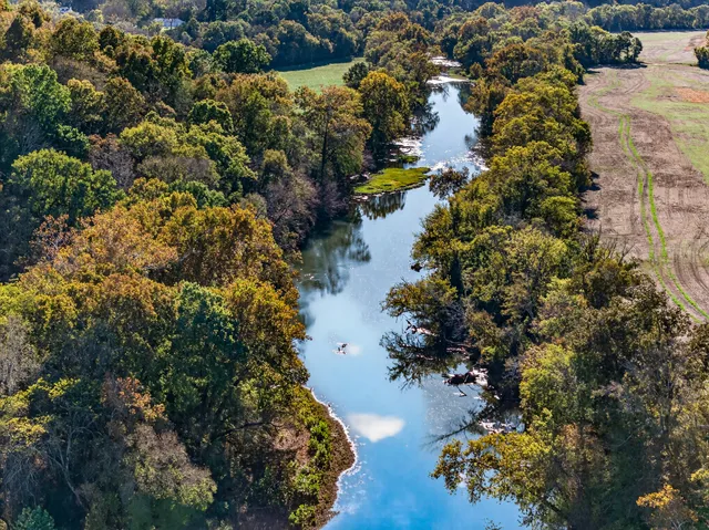 an aerial view of a houses with a yard
