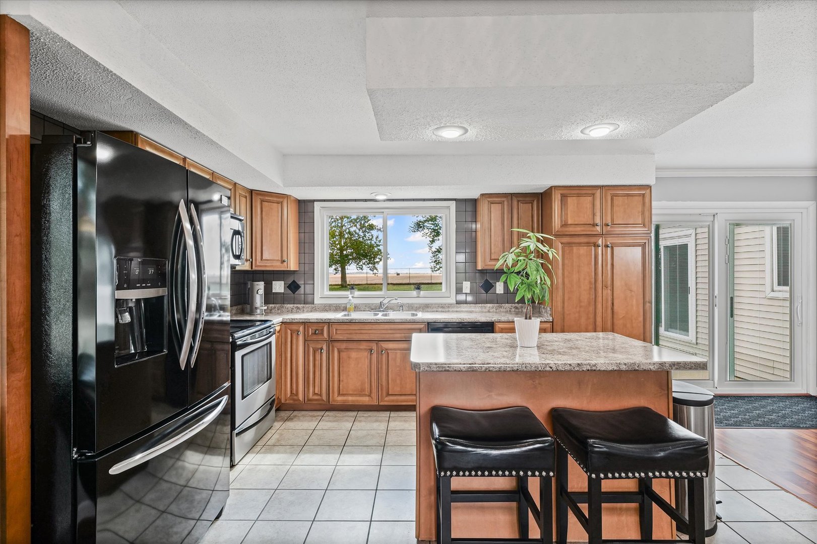 1707 West Old Church Road Champaign, IL 61822 - Photo 13 of 32 a kitchen with stainless steel appliances granite countertop a refrigerator and a stove top oven