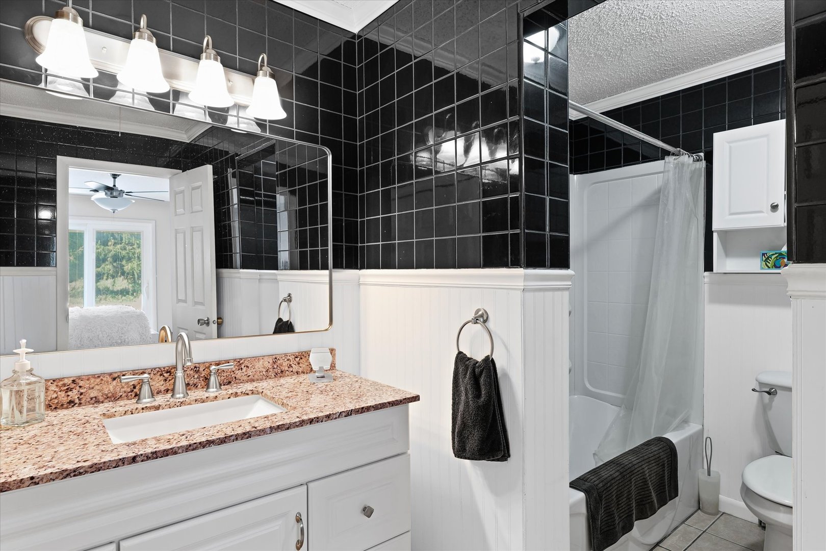 1707 West Old Church Road Champaign, IL 61822 - Photo 27 of 32 a bathroom with a granite countertop sink a toilet a mirror and shower