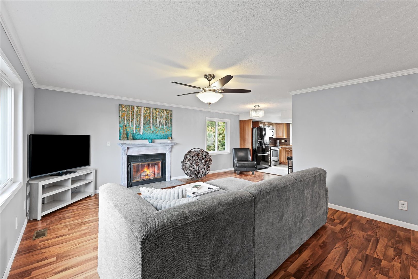 1707 West Old Church Road Champaign, IL 61822 - Photo 8 of 32 a living room with fireplace furniture a flat screen tv and a wooden floor