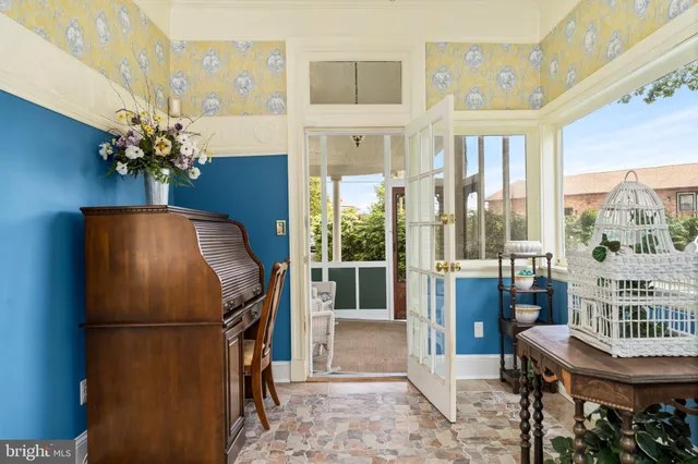 a living room with furniture a chandelier and a large window