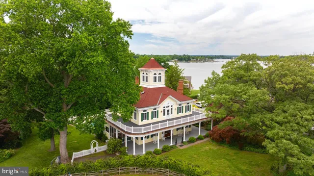 an aerial view of a houses with ocean view