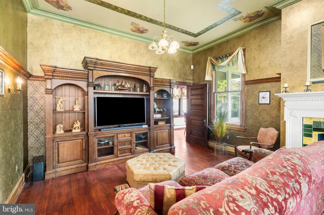 a view of a hallway with furniture and wooden floor