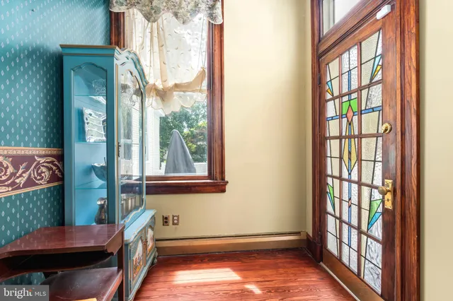 a bedroom with a bed dresser and a fireplace