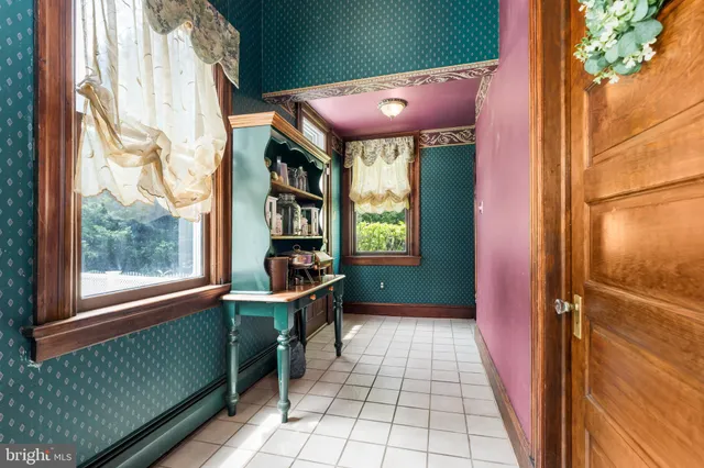 a bedroom with a bed dresser and a window