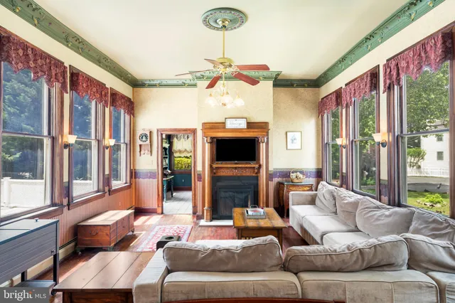 a view of living room with furniture and wooden floor