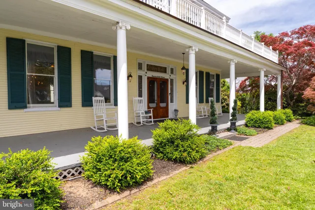 a living room with fireplace furniture and a wooden floor