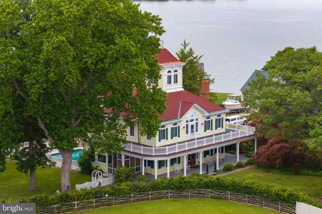 a view of a livingroom with furniture wooden floor and a fireplace