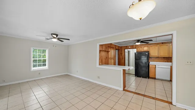 a view of an empty room with window and cabinet