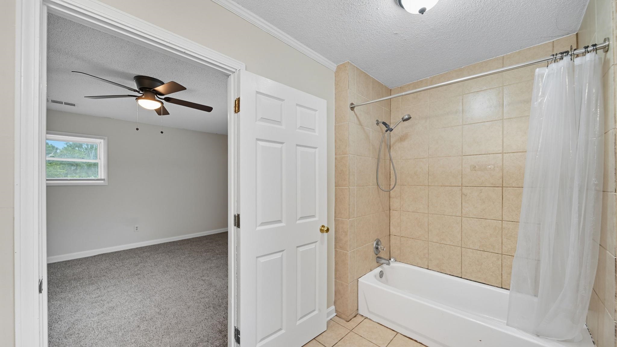 1503 Beaver Road Munford, TN 38058 - Photo 15 of 29 a bathroom with a shower and a ceiling fan