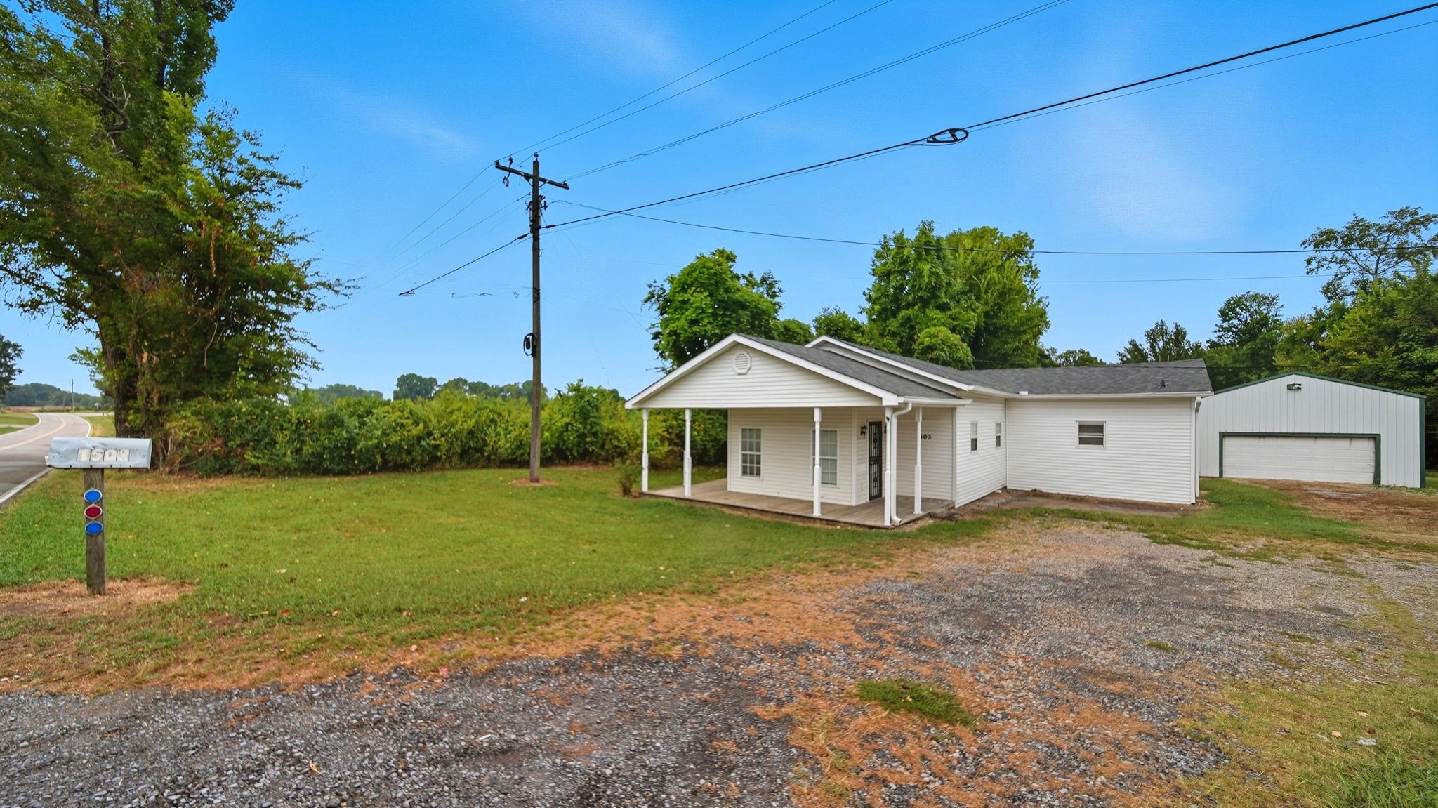 1503 Beaver Road Munford, TN 38058 - Photo 4 of 29 a view of a house next to a yard with big trees