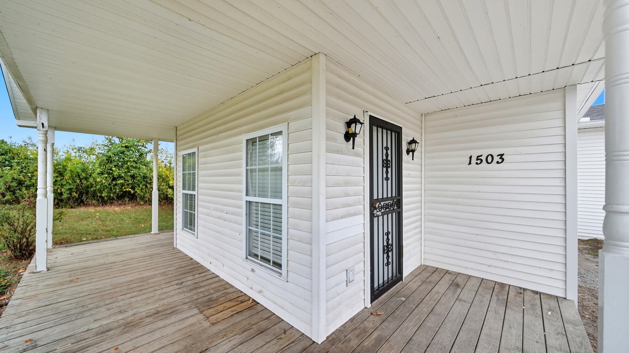 1503 Beaver Road Munford, TN 38058 - Photo 5 of 29 a view of a porch with wooden floor and floor to ceiling window