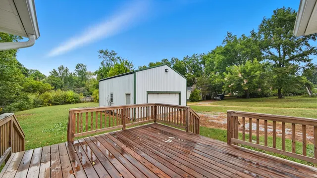 a view of a wooden deck with a yard